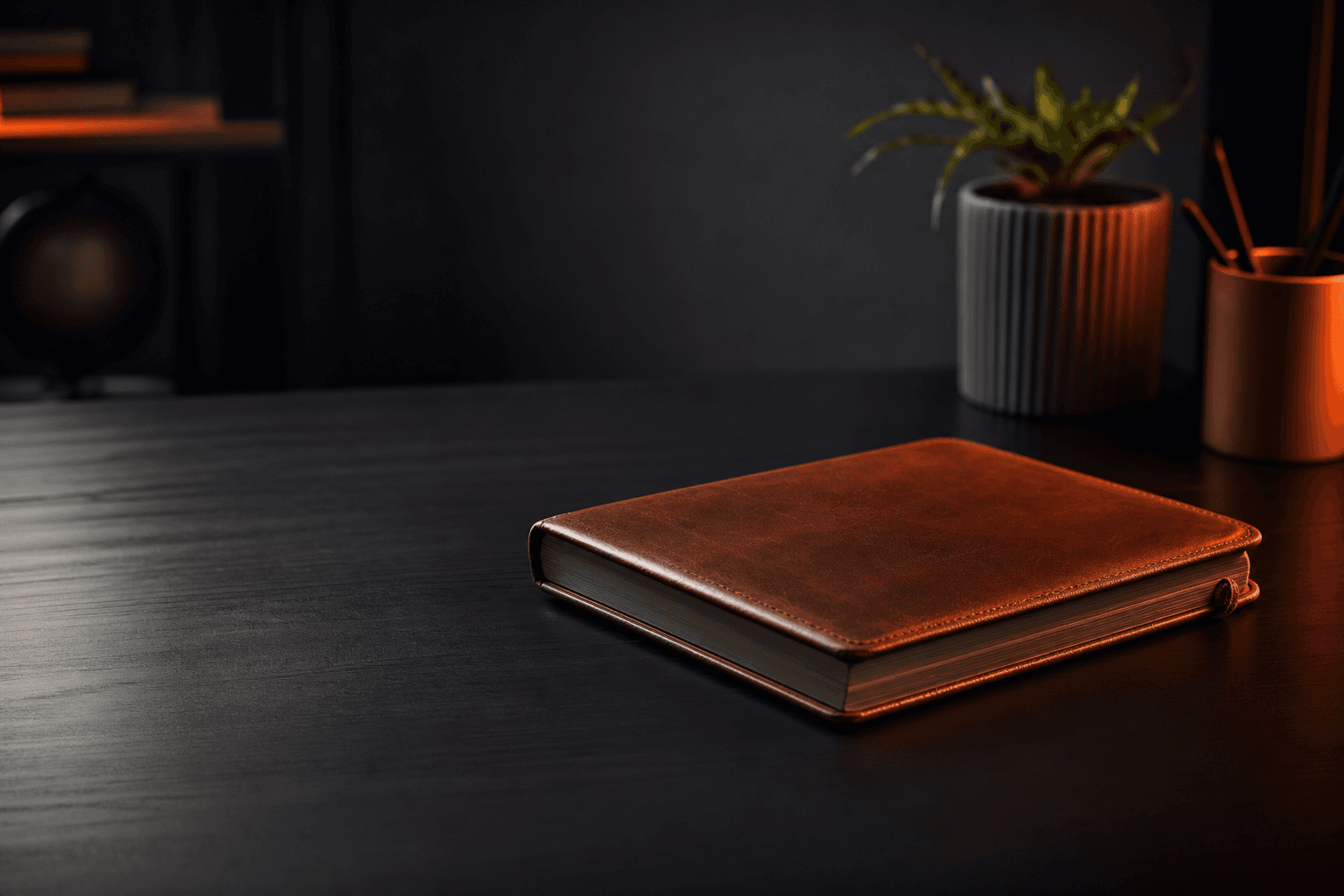 Editorial still-life of a closed notebook on a dark desk, representing FAQ content that visitors read once and leave